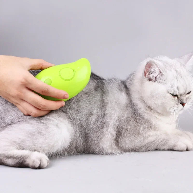 A person using a green pet steam brush on a gray cat, highlighting its ability to detangle fur and hydrate the coat.